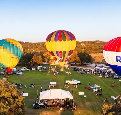 Colorful balloons on the festival grounds in golden light